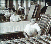 Workers building innerspring mattresses on the original factory floor