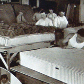 Workers on a mattress finishing line in an earlier generation